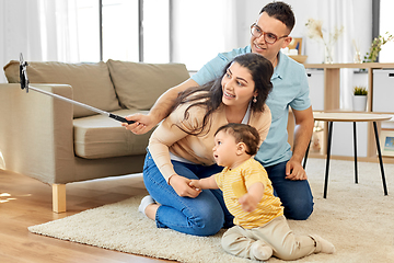 Image showing happy family with child sitting on sofa at home