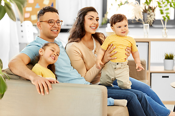 Image showing portrait of happy family sitting on sofa at home