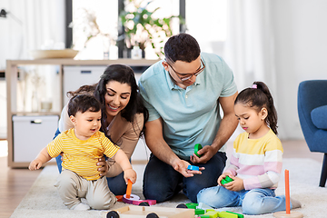 Image showing happy family palying with wooden toys at home