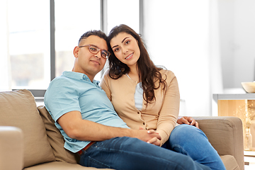 Image showing happy couple sitting on sofa at home