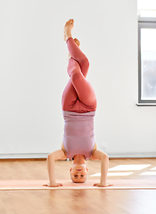 Image showing woman doing supported headstand at yoga studio