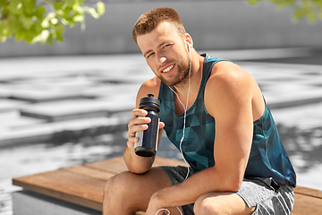 Image showing sportsman with earphones and bottle in city