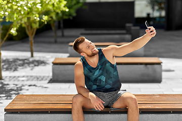 Image showing man taking selfie with smartphone outdoors