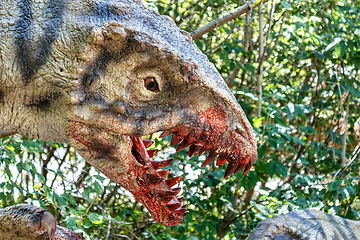 Image showing prehistoric dinosaurs raptors attacking its prey