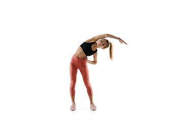 Image showing Young caucasian female model in action, motion isolated on white background. Concept of sport, movement, energy and dynamic, healthy lifestyle. Training, practicing.