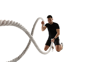 Image showing Caucasian professional sportsman training isolated on white studio background. Muscular, sportive man practicing.