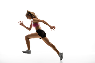 Image showing Caucasian professional female runner, athlete training isolated on white studio background. Copyspace for ad.