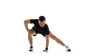 Image showing Caucasian professional sportsman training isolated on white studio background. Muscular, sportive man practicing.