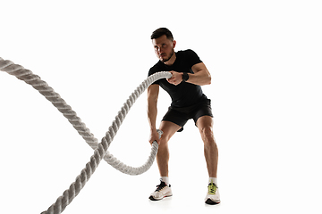 Image showing Caucasian professional sportsman training isolated on white studio background. Muscular, sportive man practicing.