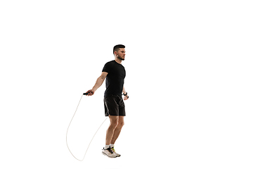 Image showing Caucasian professional sportsman training isolated on white studio background. Muscular, sportive man practicing.