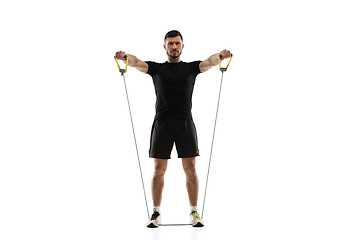 Image showing Caucasian professional sportsman training isolated on white studio background. Muscular, sportive man practicing.