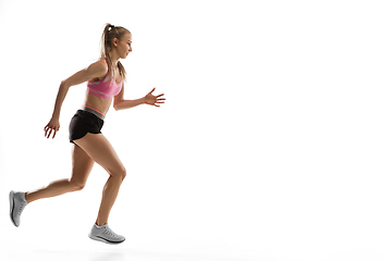 Image showing Caucasian professional female runner, athlete training isolated on white studio background. Copyspace for ad.