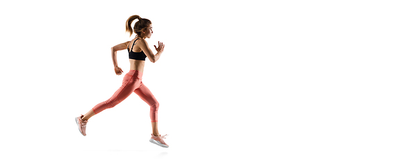 Image showing Young caucasian female model in action, motion isolated on white background. Concept of sport, movement, energy and dynamic, healthy lifestyle. Training, practicing.