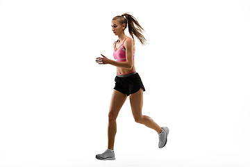 Image showing Caucasian professional female runner, athlete training isolated on white studio background. Copyspace for ad.