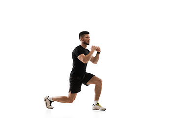 Image showing Caucasian professional sportsman training isolated on white studio background. Muscular, sportive man practicing.