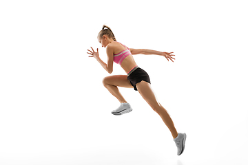 Image showing Caucasian professional female runner, athlete training isolated on white studio background. Copyspace for ad.