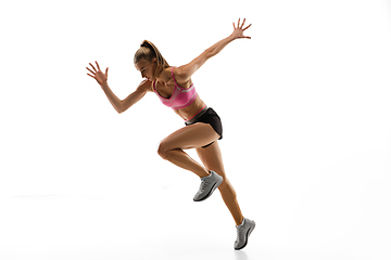 Image showing Caucasian professional female runner, athlete training isolated on white studio background. Copyspace for ad.