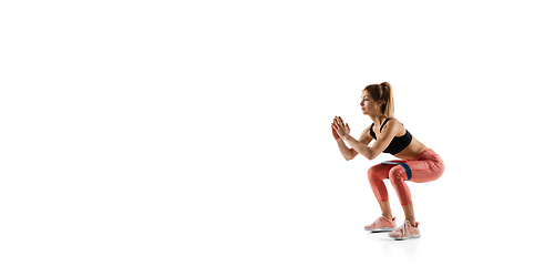 Image showing Young caucasian female model in action, motion isolated on white background. Concept of sport, movement, energy and dynamic, healthy lifestyle. Training, practicing.