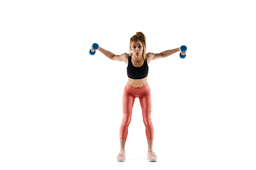 Image showing Young caucasian female model in action, motion isolated on white background. Concept of sport, movement, energy and dynamic, healthy lifestyle. Training, practicing.