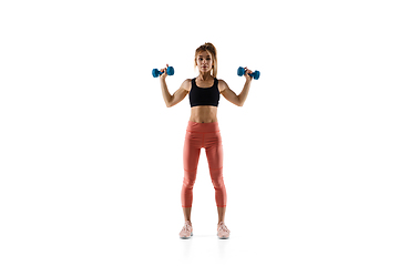 Image showing Young caucasian female model in action, motion isolated on white background. Concept of sport, movement, energy and dynamic, healthy lifestyle. Training, practicing.