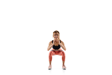 Image showing Young caucasian female model in action, motion isolated on white background. Concept of sport, movement, energy and dynamic, healthy lifestyle. Training, practicing.