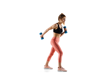 Image showing Young caucasian female model in action, motion isolated on white background. Concept of sport, movement, energy and dynamic, healthy lifestyle. Training, practicing.