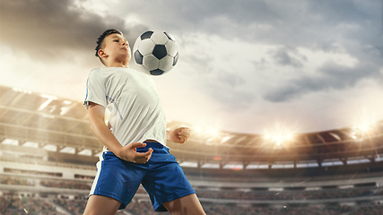 Image showing Junior football or soccer player at stadium - motion, action, activity concept