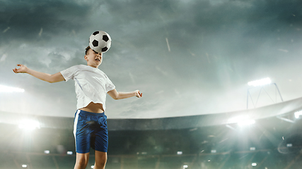 Image showing Junior football or soccer player at stadium - motion, action, activity concept