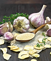 Image showing Garlic ground in spoon on board