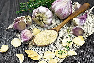 Image showing Garlic ground in spoon on burlap