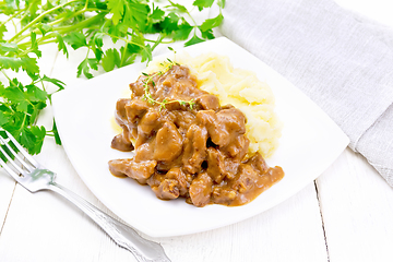 Image showing Goulash of beef with mashed potatoes in plate on white board