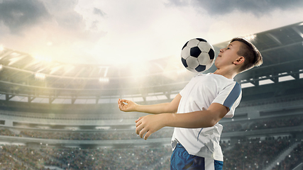 Image showing Junior football or soccer player at stadium - motion, action, activity concept