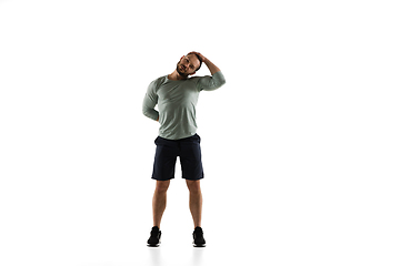 Image showing Young caucasian male model in action, motion isolated on white background. Concept of sport, movement, energy and dynamic, healthy lifestyle. Training, practicing.