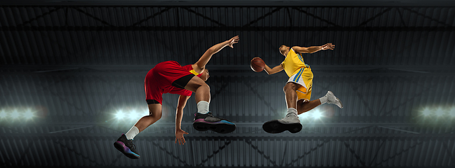 Image showing Young basketball players in competitive fight, motion in flight on black background, look from the bottom. Concept of sport, movement, energy and dynamic.