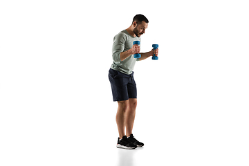 Image showing Young caucasian male model in action, motion isolated on white background. Concept of sport, movement, energy and dynamic, healthy lifestyle. Training, practicing.