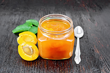 Image showing Jam apricot in jar on black board