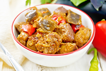 Image showing Meat with eggplant and pepper in bowl on board