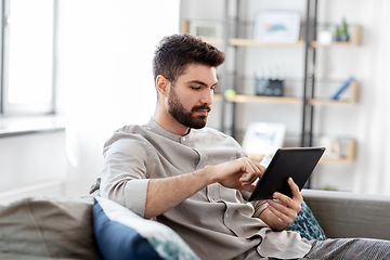 Image showing man with tablet computer at home