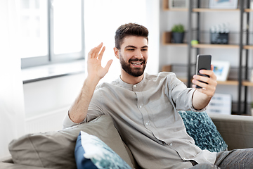 Image showing man with smartphone having video call at home