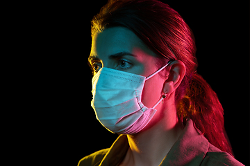 Image showing young woman wearing protective medical mask