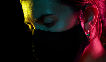 Image showing young woman wearing reusable protective mask