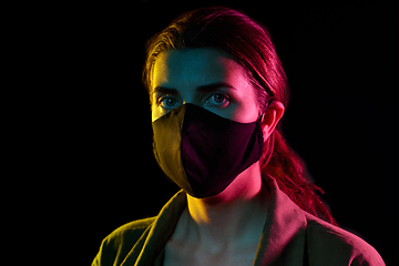 Image showing young woman wearing reusable protective mask
