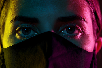 Image showing young woman wearing reusable protective mask