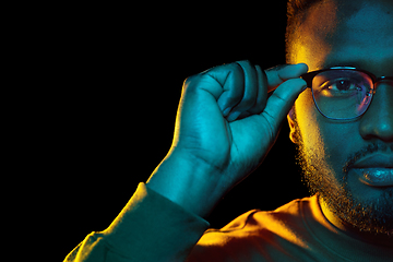 Image showing young african american man in glasses over black