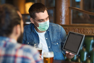 Image showing men in masks with tablet pc drink beer at bar