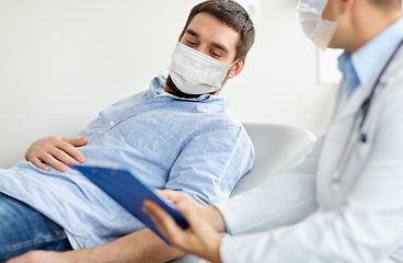 Image showing male doctor and patient in masks at hospital