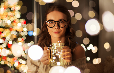 Image showing woman with christmas garland lights in glass mug