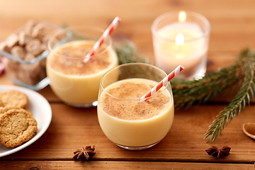 Image showing glasses of eggnog, oatmeal cookies and fir branch