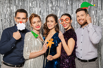Image showing happy friends posing with christmas party props