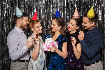 Image showing happy friends in party hats with birthday gift